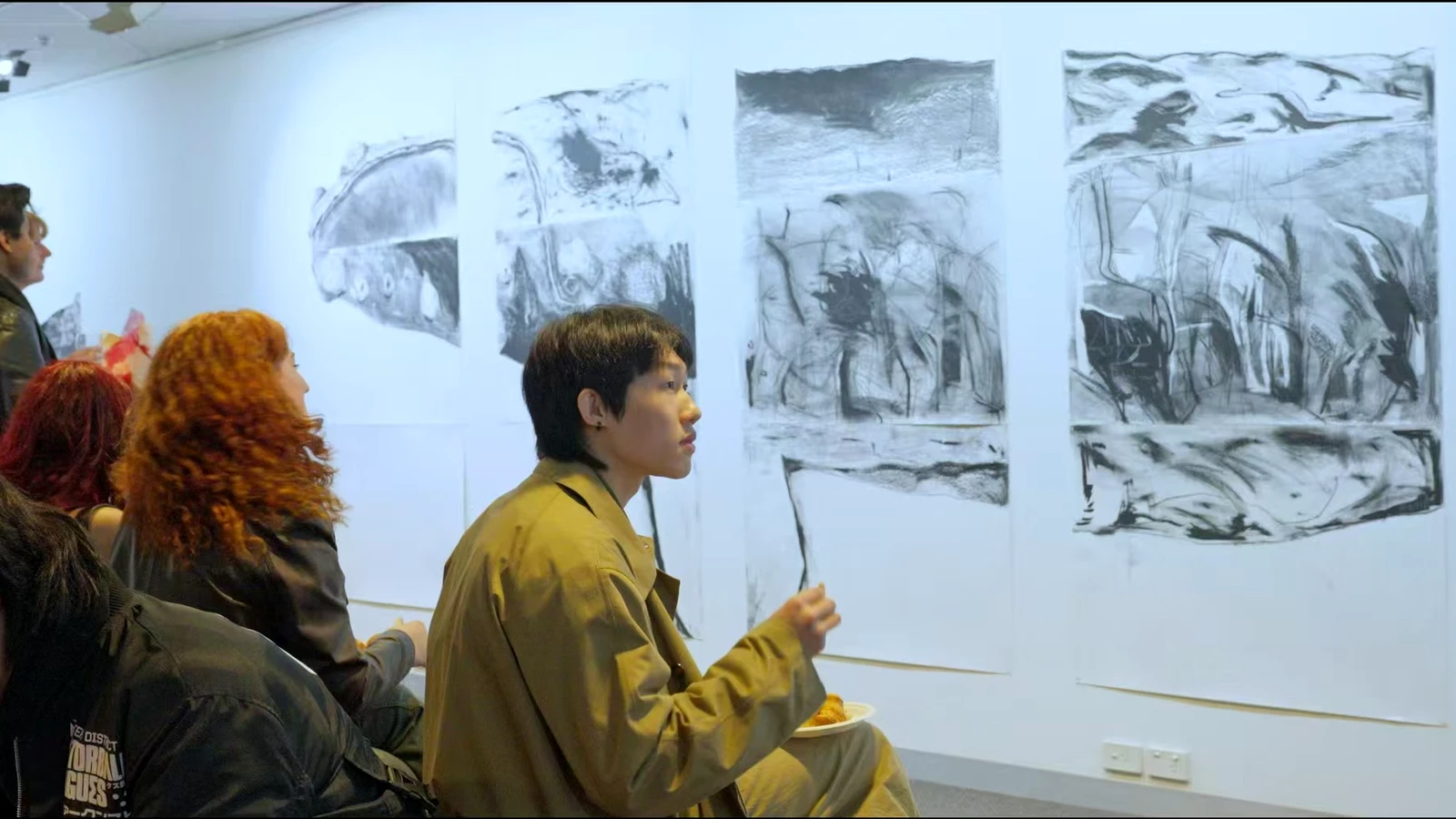 Audience encountering emerging artists’ work during Emerging Art Beat 2025